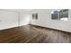 Bedroom with laminate floors, double door closet, and natural light at 12375 Ivy Pl, Brighton, CO 80602