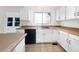 Bright eat-in kitchen featuring white cabinets, contrasting countertops, tile floors, and stainless steel dishwasher at 12375 Ivy Pl, Brighton, CO 80602