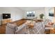 This staged living room features hardwood floors, neutral paint, modern furniture, area rug, and a large window at 12375 Ivy Pl, Brighton, CO 80602