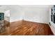 Bright living room featuring hardwood floors and neutral paint, offering a versatile space at 12375 Ivy Pl, Brighton, CO 80602