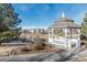 Quaint gazebo by a pond, with homes and trees in the background at 20697 E Lake Ave, Centennial, CO 80016