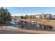 Peaceful pond with a footbridge, surrounded by homes and trees at 20697 E Lake Ave, Centennial, CO 80016