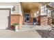 Inviting front porch with brick columns and a charming sitting area at 20697 E Lake Ave, Centennial, CO 80016