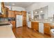 Bright kitchen with oak cabinets, hardwood floors, and stainless steel appliances at 20697 E Lake Ave, Centennial, CO 80016