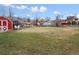 Lush backyard with a red shed and open green space, ideal for relaxation and outdoor enjoyment at 445 S Depew St, Lakewood, CO 80226