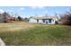 Exterior view of the house and backyard, showcasing the well-maintained lawn and home design at 445 S Depew St, Lakewood, CO 80226