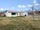 Exterior shot of the property showcasing a wooden deck, well-maintained lawn, and garage at 445 S Depew St, Lakewood, CO 80226