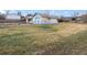 Exterior shot of the home featuring a garage and expansive backyard with a well-kept lawn at 445 S Depew St, Lakewood, CO 80226