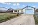 Exterior showing a garage with an American flag, a small deck, and a chain-link fence at 445 S Depew St, Lakewood, CO 80226