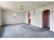 Simple living room with arched doorways and a large window providing natural light at 445 S Depew St, Lakewood, CO 80226