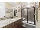 Modern bathroom featuring granite countertops, a walk-in shower, and dark wood cabinetry at 1995 Wingfeather Ln, Castle Rock, CO 80108