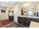 Bathroom with double vanity, granite countertop, dark wood cabinets, and large walk-in shower at 1995 Wingfeather Ln, Castle Rock, CO 80108