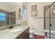 Well-lit bathroom with sleek vanity, framed mirror, and a glass-enclosed shower at 1995 Wingfeather Ln, Castle Rock, CO 80108