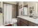 Modern bathroom featuring gray tiled shower, a granite countertop, and a framed mirror at 1995 Wingfeather Ln, Castle Rock, CO 80108