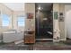 Bright bathroom featuring a standalone tub, glass enclosed shower, and elegant slate floors at 1995 Wingfeather Ln, Castle Rock, CO 80108