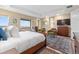 Bright bedroom with tray ceilings, views, seating area, and wood furniture details at 1995 Wingfeather Ln, Castle Rock, CO 80108