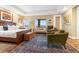 Spacious bedroom features a wooden bed frame, sitting area, mountain views and an exquisite area rug at 1995 Wingfeather Ln, Castle Rock, CO 80108