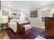 Bright and airy bedroom features a wooden bed, area rug, bedside tables, and natural lighting at 1995 Wingfeather Ln, Castle Rock, CO 80108