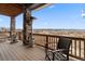 Spacious covered deck with scenic views, outdoor heater, and comfortable seating arrangement at 1995 Wingfeather Ln, Castle Rock, CO 80108