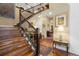 Elegant foyer features a staircase with wood treads, iron spindles, and views into formal living spaces at 1995 Wingfeather Ln, Castle Rock, CO 80108
