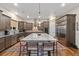 Modern kitchen with stainless appliances, granite countertops, hardwood floors, and large center island at 1995 Wingfeather Ln, Castle Rock, CO 80108