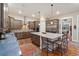 Modern kitchen featuring stainless appliances, granite countertops, hardwood floors, and a spacious center island at 1995 Wingfeather Ln, Castle Rock, CO 80108