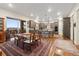 A spacious kitchen with stainless appliances, granite countertops, wood floors, a center island, and a view from the eating area at 1995 Wingfeather Ln, Castle Rock, CO 80108