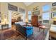 Spacious living room with soaring ceilings, wooden floors, and natural light from oversized picture windows at 1995 Wingfeather Ln, Castle Rock, CO 80108