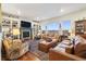 Inviting living room with custom built-ins, fireplace, and large windows offering panoramic views at 1995 Wingfeather Ln, Castle Rock, CO 80108