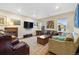 Inviting living room with comfortable seating, decorative art, and ample natural light at 1995 Wingfeather Ln, Castle Rock, CO 80108