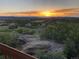 Scenic view of sunset over a distant town from a property's outdoor living space with native landscaping at 1995 Wingfeather Ln, Castle Rock, CO 80108