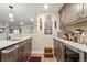 Basement wet bar area featuring stainless steel appliances and gray cabinets at 1995 Wingfeather Ln, Castle Rock, CO 80108