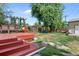 Spacious backyard with deck, playset, and mature trees at 2311 W 46Th Ave, Denver, CO 80211