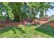 Landscaped backyard with seating area under shade tree at 2311 W 46Th Ave, Denver, CO 80211