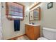 Clean bathroom with wood vanity, single sink, and shower/tub combo at 2311 W 46Th Ave, Denver, CO 80211