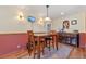 Bright dining area with wood table and chairs, built-in cabinetry, and hardwood floors at 2311 W 46Th Ave, Denver, CO 80211