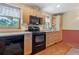 Kitchen with wood cabinets, black appliances, and ample counter space at 2311 W 46Th Ave, Denver, CO 80211