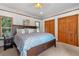 Spacious main bedroom with large bed, wood dresser, and backyard access at 2311 W 46Th Ave, Denver, CO 80211