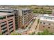 Elevated view of apartments featuring a parking garage, rooftop decks, and nearby walkable shops and dining at 20 Wilcox St # 318, Castle Rock, CO 80104