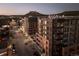 Night aerial view highlighting a modern apartment complex with city views and picturesque mountain backdrop at 20 Wilcox St # 318, Castle Rock, CO 80104
