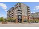 Corner view of an attractive apartment complex featuring balconies, restaurants, and street parking at 20 Wilcox St # 318, Castle Rock, CO 80104