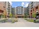 Attractive apartment building featuring a manicured courtyard, benches, and central entrance area at 20 Wilcox St # 318, Castle Rock, CO 80104