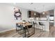 Modern dining area with a wooden table, seating for four, and a view of the kitchen and modern lighting at 20 Wilcox St # 318, Castle Rock, CO 80104