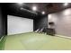 An indoor golf simulator room featuring a screen and golf clubs at 20 Wilcox St # 318, Castle Rock, CO 80104