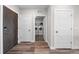 Hallway with wood floors, white trim, and access to the laundry room and other rooms in the home at 20 Wilcox St # 318, Castle Rock, CO 80104