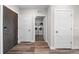 Entry hallway features hardwood floors, closet space, and a convenient in-unit laundry area at 20 Wilcox St # 318, Castle Rock, CO 80104