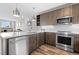 Modern kitchen featuring stainless steel appliances, wood cabinets and a stylish white backsplash at 20 Wilcox St # 318, Castle Rock, CO 80104