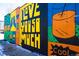 Colorful mural featuring bold graphics and uplifting messages, creating a vibrant public art display at 20 Wilcox St # 318, Castle Rock, CO 80104