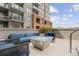 Relaxing outdoor patio with comfortable seating around a modern fire pit and city views at 20 Wilcox St # 318, Castle Rock, CO 80104