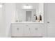 Well-lit bathroom featuring double sinks, modern fixtures, and plenty of counter space at 126 S Vandriver Way, Aurora, CO 80018